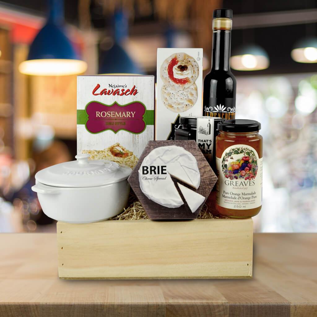 Indulge someone with the Coffee & Brie Baker Gift Set. It has brie cheese,  a brie baker, coffee, a dark chocolate bar, pistachios, bruschetta, garlic  & tomato bread dipper, cocktail sauce, crackers